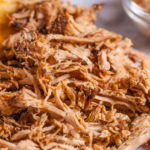 Close up shot of pulled pork fibers in a sandwich freshy served on a platter